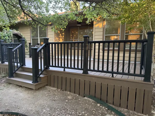 Rebuilt wood deck with black railings and new stairs